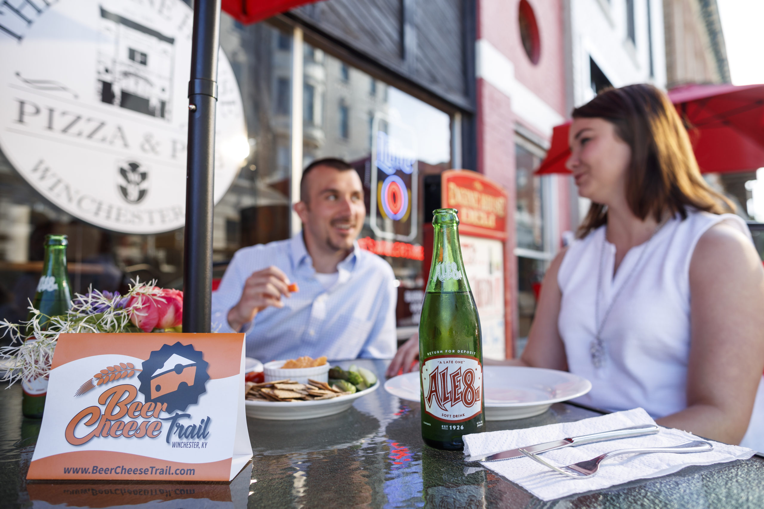 couple enjoying beer cheese and Ale 8 One